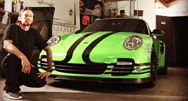 Installer with a lime green Porsche 911 Turbo with black stripes