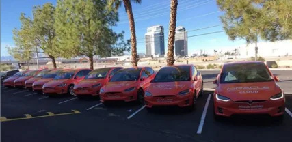 Row of matching branded Tesla Model X fleet vehicles